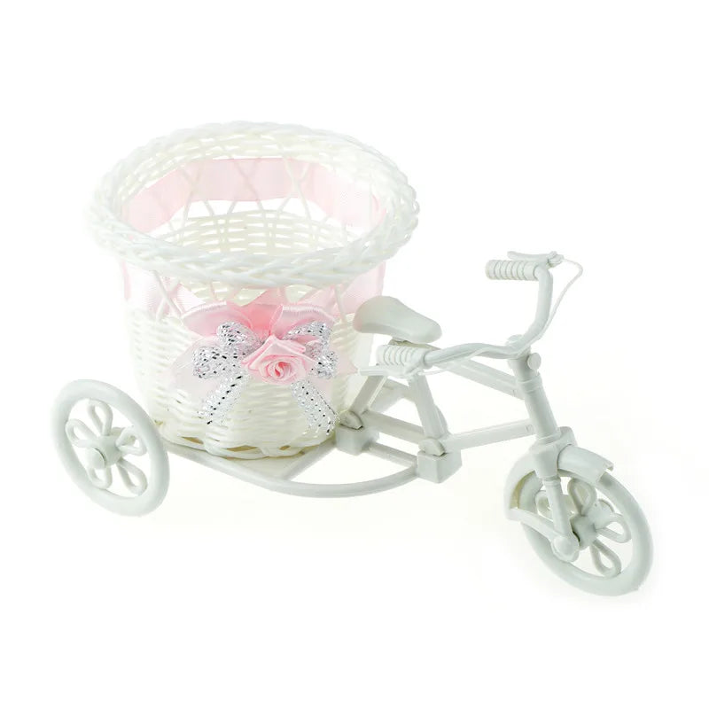 Add charm to any occasion with our Tricycle Basket Container. Crafted from durable rattan, it's perfect for flowers, candy, and more. Available in white with colorful ribbon accents.