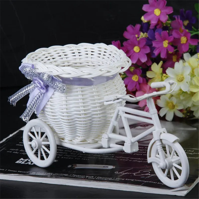 Add charm to any occasion with our Tricycle Basket Container. Crafted from durable rattan, it's perfect for flowers, candy, and more. Available in white with colorful ribbon accents.