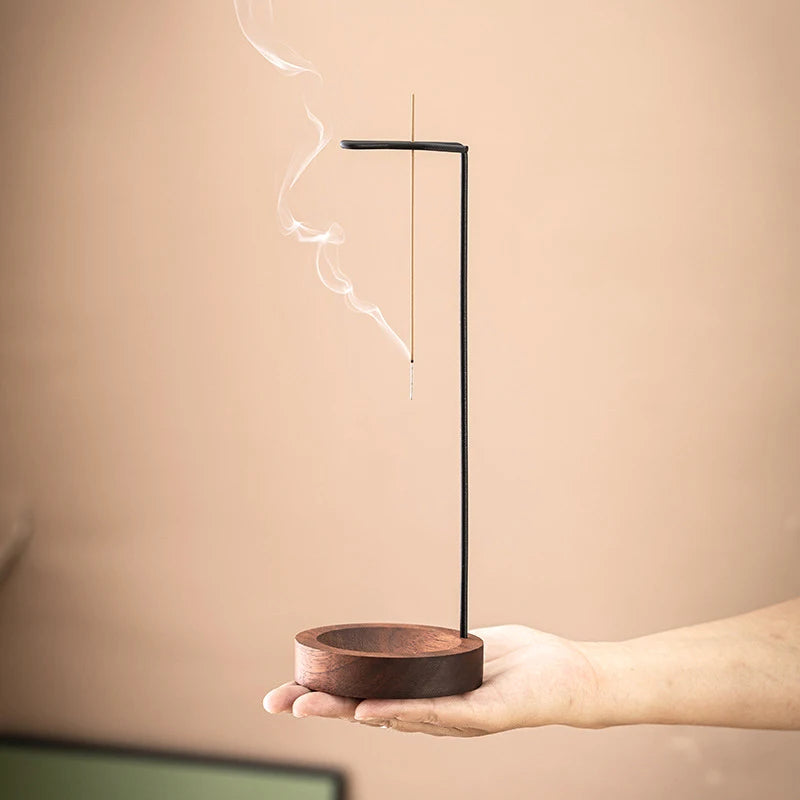 This elegant incense holder features a durable wood base and metal stick stand, with an innovative upside-down design for efficient burning. Ideal for peaceful spaces.