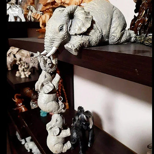 This hand-crafted resin elephant figurine set features a mama elephant lovingly holding her baby, symbolizing family and love. Ideal for Mother's Day or home decor.