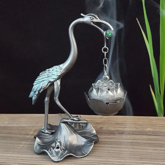 Elevate your space with our Traditional Chinese Crane Bird Incense Burner. Standing 13 cm tall, this metal piece blends elegance and tranquility with a green bead accent.