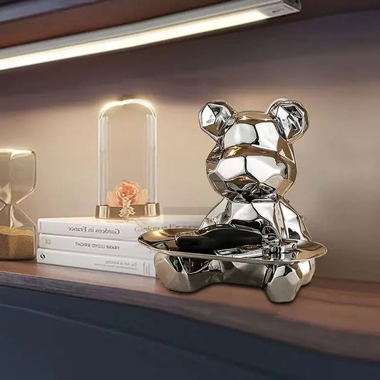 Add modern charm with our Geometric Bear Statue with Tray. Crafted from premium ceramic, it features a versatile metal tray and discreet money slot. Perfect for decor and gifting.