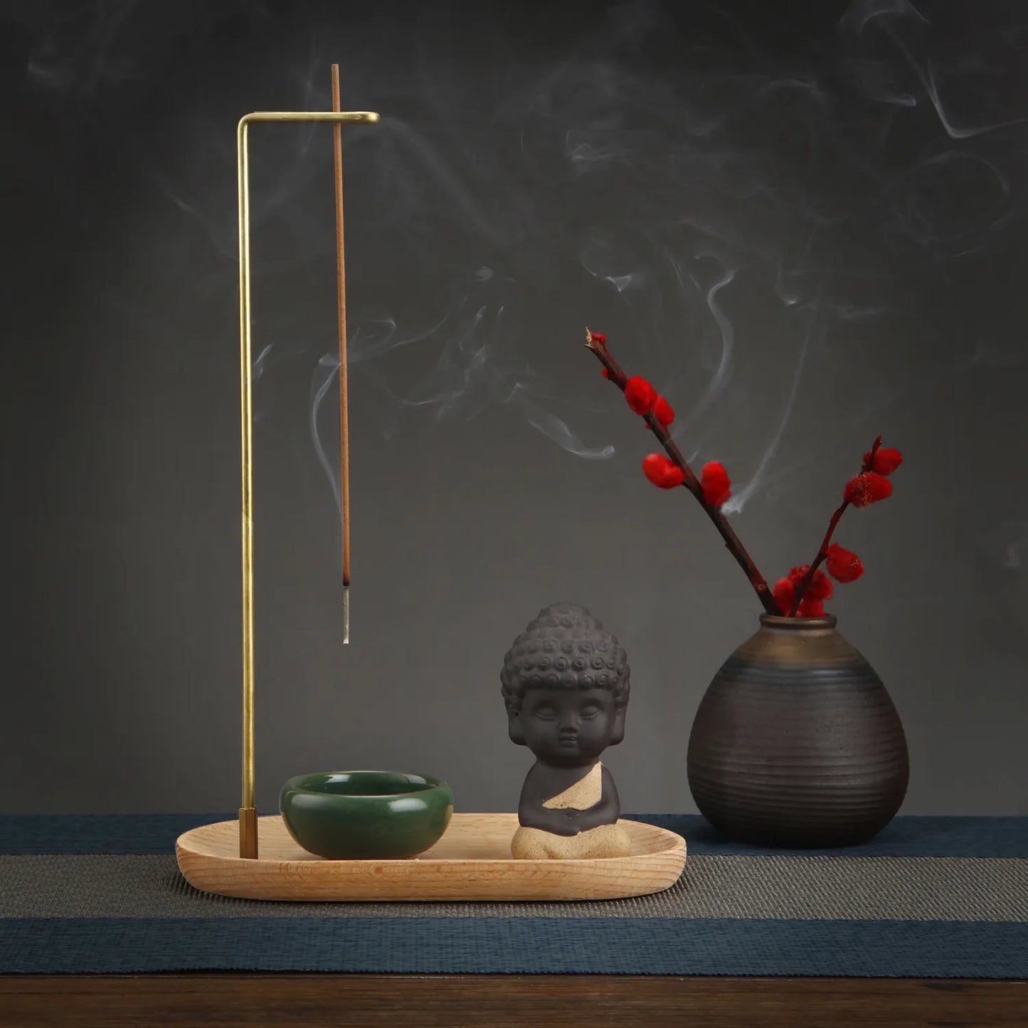 Enhance your space with the Creative Ceramic Little Monk Incense Burner Set. Crafted from ceramic, brass, and wood, it offers serenity and elegance with its charming design.