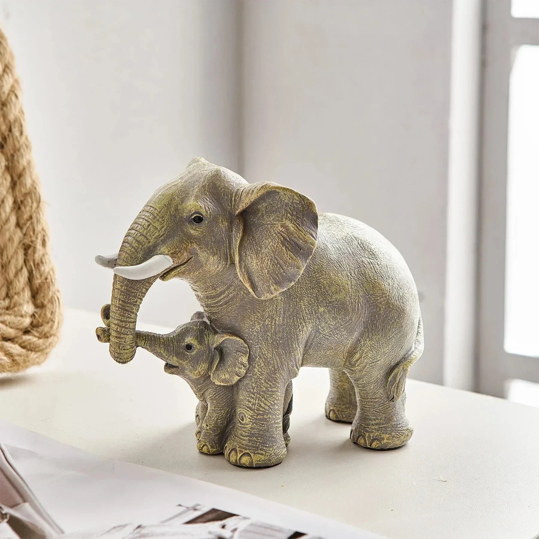 Lifelike resin statue of a mummy and baby elephant, perfect for nature lovers. Durable and charming, ideal for gifts and home decor.