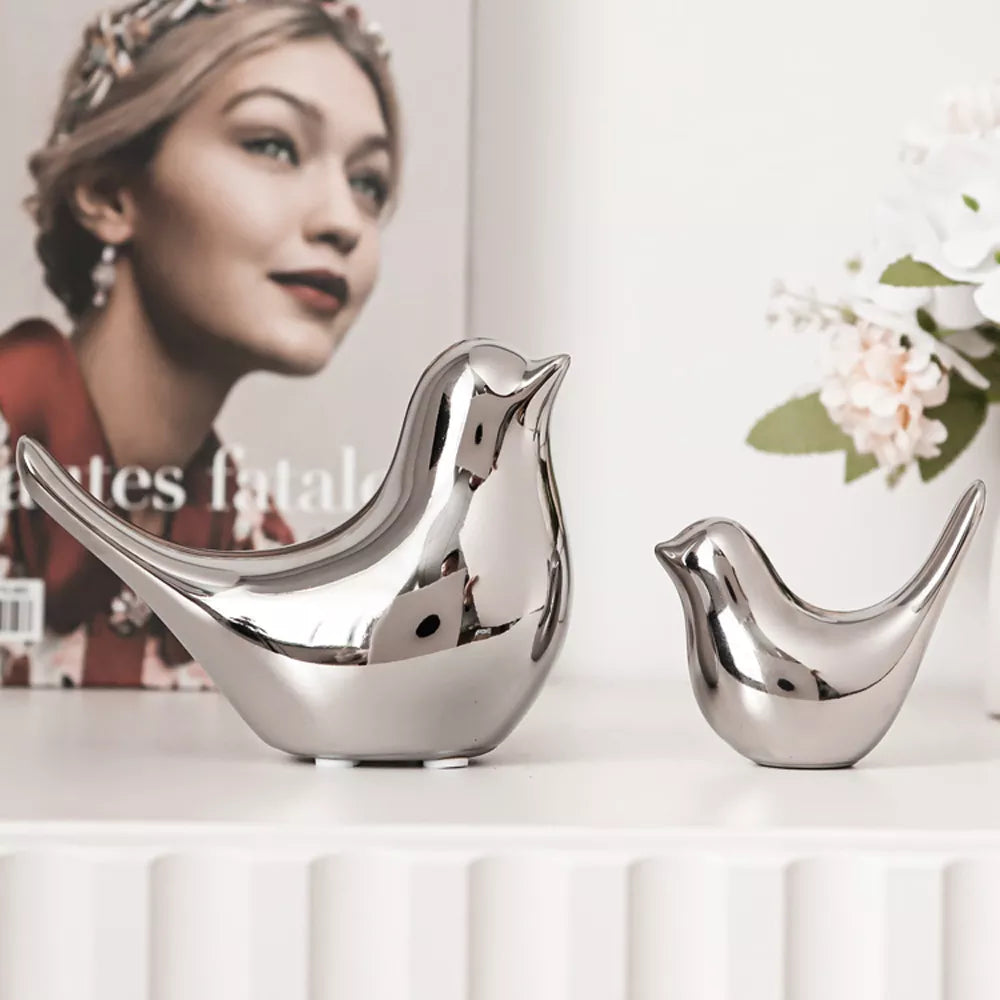 Elevate your decor with Modern Simple Luxury Silver and Golden Ceramic Bird Figurines. Crafted from high-quality ceramic with a sleek finish, these pieces add opulence and sophistication to any space.