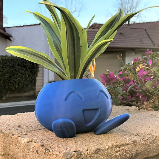 Add a whimsical touch to your space with this Oddish-inspired flower pot. Perfect for small plants, it features a waterproof plastic design in vibrant blue, ideal for fans and gardeners.