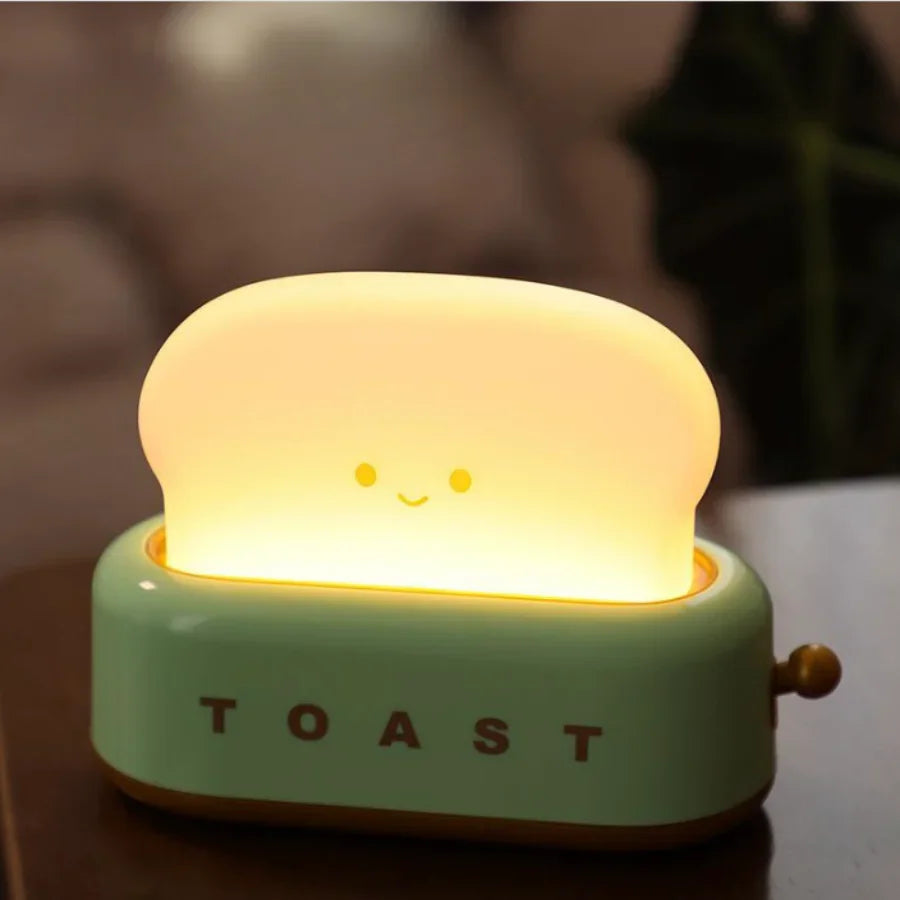 A quirky and modern nightlight designed to add a fun, functional touch to your bedroom decor. Shaped like a toaster, this LED lamp combines style with practicality. Features Modern Design: Shaped like a toaster, this unique nightlight adds a playful and contemporary touch to your room. Touch Control: Easily adjust the light with a simple touch, allowing you to customize the brightness. Rechargeable: Comes with a built-in 1200mAh battery that can be recharged via USB, providing convenience without the need f