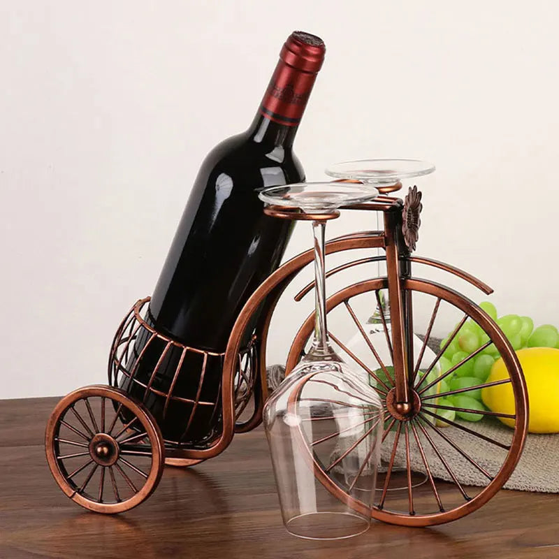 Elevate your decor with the Retro Carriage Bike Wine Rack. Vintage-inspired design in bronze metal features a wine bottle holder and glass hangers for a charming touch.