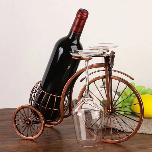 Elevate your decor with the Retro Carriage Bike Wine Rack. Vintage-inspired design in bronze metal features a wine bottle holder and glass hangers for a charming touch.