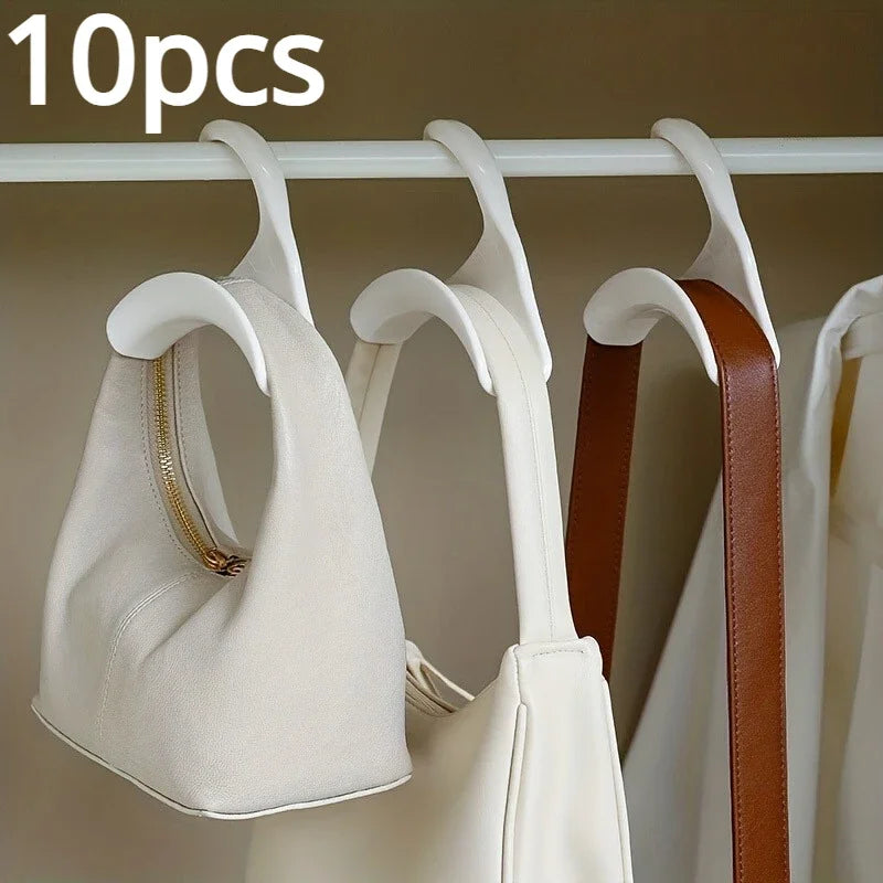 Accessory organizer racks: Unique widening design prevents creases. Ideal for purses, ties, belts, and more. Durable plastic, available in white and black. Compact 10.5 x 10.5 x 3.5 cm, set of 10.